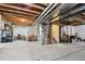 Unfinished basement with exposed ductwork provides a blank canvas for customization and offers ample potential at 16188 Elizabeth St, Thornton, CO 80602