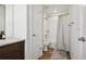 Bright bathroom features a bathtub with shower, white tile surround, and neutral color scheme at 16188 Elizabeth St, Thornton, CO 80602