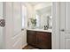Well-lit bathroom featuring a vanity with a granite countertop, a mirror, and modern fixtures at 16188 Elizabeth St, Thornton, CO 80602