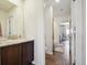 Modern bathroom featuring a dark wood vanity with a white countertop and stylish fixtures at 16188 Elizabeth St, Thornton, CO 80602