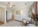 Bright bedroom with modern decor, dresser, accent chair, and wood-look floors at 16188 Elizabeth St, Thornton, CO 80602