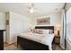 This bedroom features a queen bed with stylish decor, natural lighting, and modern flooring at 16188 Elizabeth St, Thornton, CO 80602