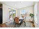 Bright dining area features a sliding glass door, wood floors, modern lighting, and a round wooden table at 16188 Elizabeth St, Thornton, CO 80602