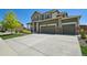 Charming two-story home with a three car garage, manicured lawn, and stone accents at 16188 Elizabeth St, Thornton, CO 80602