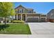 Charming two-story home with a three car garage, manicured lawn, and stone accents at 16188 Elizabeth St, Thornton, CO 80602
