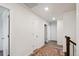 Hallway features neutral walls, hardwood floors, and classic doors leading to various rooms at 16188 Elizabeth St, Thornton, CO 80602