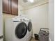 Functional laundry room featuring modern washer and dryer, with ample storage at 16188 Elizabeth St, Thornton, CO 80602