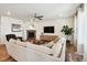 Comfortable living room with fireplace, lots of natural light, and hardwood floors at 16188 Elizabeth St, Thornton, CO 80602