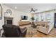 Bright living room with fireplace, hardwood floors, and neutral decor at 16188 Elizabeth St, Thornton, CO 80602