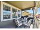 Cozy covered patio featuring comfortable seating, an outdoor grill, and a relaxing atmosphere with neighborhood views at 16188 Elizabeth St, Thornton, CO 80602