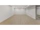 A spacious basement features plank flooring, white walls and ceiling, and recessed lighting at 4580 Garland St, Wheat Ridge, CO 80033