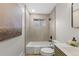 Bright bathroom featuring a modern vanity, neutral tiling, and a shower-tub combo at 4580 Garland St, Wheat Ridge, CO 80033