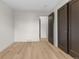 Bright bedroom with minimalist decor featuring modern flooring and closet with black doors at 4580 Garland St, Wheat Ridge, CO 80033