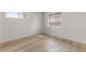 A bright bedroom with hardwood flooring and natural light from two windows at 4580 Garland St, Wheat Ridge, CO 80033