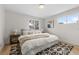 Cozy bedroom featuring a queen-sized bed, a geometric rug, and natural light from two windows at 4580 Garland St, Wheat Ridge, CO 80033