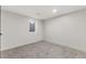 Finished basement with neutral carpet, white walls, and a small window at 4580 Garland St, Wheat Ridge, CO 80033