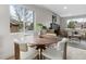 Cozy dining area with modern table, plush chairs, and large window at 4580 Garland St, Wheat Ridge, CO 80033
