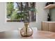 Dining table decor with large plant, wood furniture, and bright window views at 4580 Garland St, Wheat Ridge, CO 80033