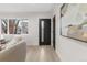 Modern entryway with sleek black door, wood flooring, and stylish artwork at 4580 Garland St, Wheat Ridge, CO 80033
