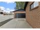 Modern garage with sleek black door and a spacious driveway at 4580 Garland St, Wheat Ridge, CO 80033
