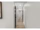 Bright hallway featuring wood floors and multiple dark wood doors, creating an inviting passage at 4580 Garland St, Wheat Ridge, CO 80033