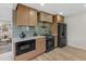 Bright kitchen featuring wooden cabinets, a modern range hood, and sleek black appliances at 4580 Garland St, Wheat Ridge, CO 80033