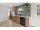 Spacious kitchen with modern appliances, green tile, and wood cabinets open to other rooms at 4580 Garland St, Wheat Ridge, CO 80033