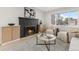 Inviting living room with a cozy fireplace, stylish furnishings, and ample natural light at 4580 Garland St, Wheat Ridge, CO 80033