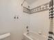 Tiled bathroom features a shower-tub combo with decorative tile at 11851 Elm Dr, Thornton, CO 80233
