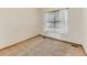 Bedroom featuring neutral carpet, baseboard trim, and a window at 11851 Elm Dr, Thornton, CO 80233