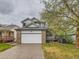 Charming two-story home with a brick-accented garage and inviting front porch at 11851 Elm Dr, Thornton, CO 80233