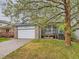Charming two-story home with a brick-accented garage, porch, and mature tree at 11851 Elm Dr, Thornton, CO 80233