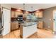Charming kitchen features an island with granite countertop, stainless steel appliances, and wood cabinets at 11851 Elm Dr, Thornton, CO 80233