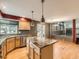 Open concept kitchen with wood cabinets, granite countertop island, and stainless steel appliances at 11851 Elm Dr, Thornton, CO 80233