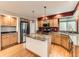 Bright kitchen featuring an island with granite countertop, stainless steel appliances, and wood cabinets at 11851 Elm Dr, Thornton, CO 80233