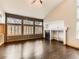 Bright living room featuring hardwood floors, a fireplace, and large windows at 11851 Elm Dr, Thornton, CO 80233