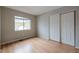 Bedroom features wood floors, a window, and a closet with sliding doors at 10117 Wyandott N Cir, Denver, CO 80260