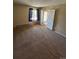 Bedroom with carpet, window, and a doorway that leads to an outdoor space at 14751 E Tennessee Dr # 222, Aurora, CO 80012
