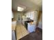 Bright kitchen with white cabinets, tiled floor, and newer appliances at 14751 E Tennessee Dr # 222, Aurora, CO 80012