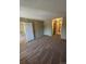 Spacious carpeted living room showing doorways leading to other rooms at 14751 E Tennessee Dr # 222, Aurora, CO 80012