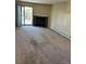 Open living room with neutral carpet, fireplace, and sliding glass door to deck at 14751 E Tennessee Dr # 222, Aurora, CO 80012