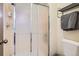 Bathroom featuring a shower with sliding doors, toilet, and towel rack with gray towels at 9957 Grove Way # F, Westminster, CO 80031