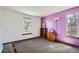 Cozy bedroom featuring natural light from the windows and calming lavender accent wall at 9957 Grove Way # F, Westminster, CO 80031