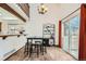 Open dining area with a view of the patio, featuring modern black chairs, a table, and wood-look floors at 9957 Grove Way # F, Westminster, CO 80031