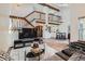 Open living area with vaulted ceilings, wood beams, a staircase, and access to the kitchen and dining area at 9957 Grove Way # F, Westminster, CO 80031