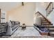 Inviting living room featuring vaulted ceilings, a gray sofa, and stairs leading to a second floor at 9957 Grove Way # F, Westminster, CO 80031