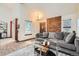 Cozy living room with a gray sofa, brick wall accent, and a sliding glass door for ample natural light at 9957 Grove Way # F, Westminster, CO 80031