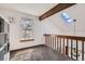 Bright loft area with wood beam accents, skylight, and plush carpet at 9957 Grove Way # F, Westminster, CO 80031