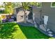 Aerial view of the backyard with a patio, lush lawn, and well-maintained landscaping at 1750 E Noble Pl, Centennial, CO 80121