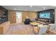 Finished basement offering a casual living space with comfortable seating, wood paneling and a convenient rear exit at 1750 E Noble Pl, Centennial, CO 80121